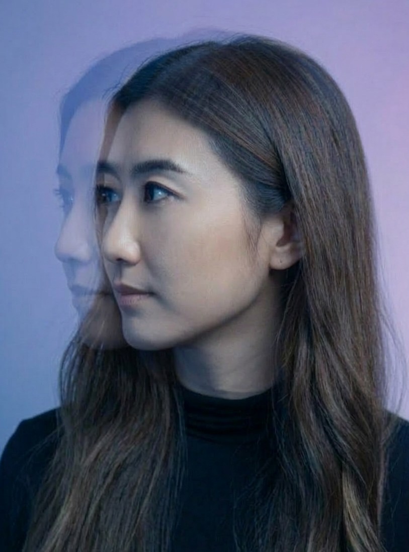 Portrait of Whitney Sheng with a layered blue-toned double-exposure effect.